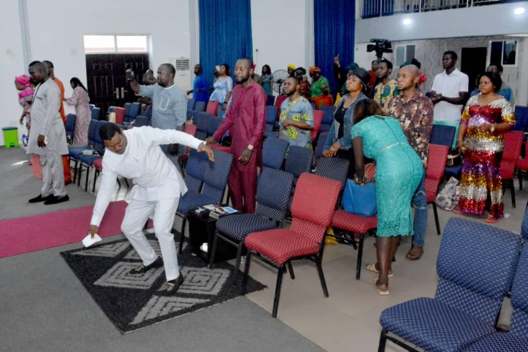 Members dancing and celebrating in colorful outfits