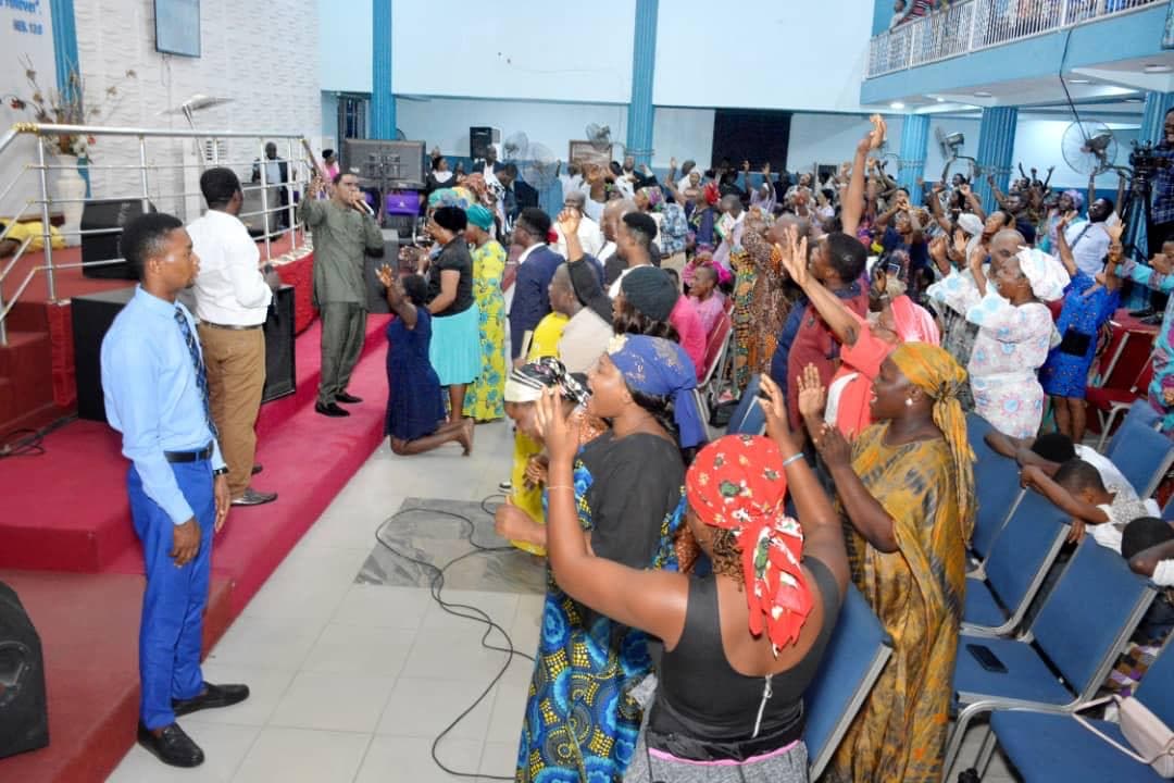 Pastor anointing a man with oil during ministry time
